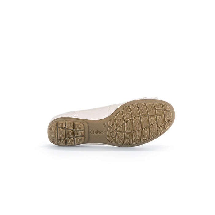 White ballet flat outsole with tan rubber tread and rounded toe