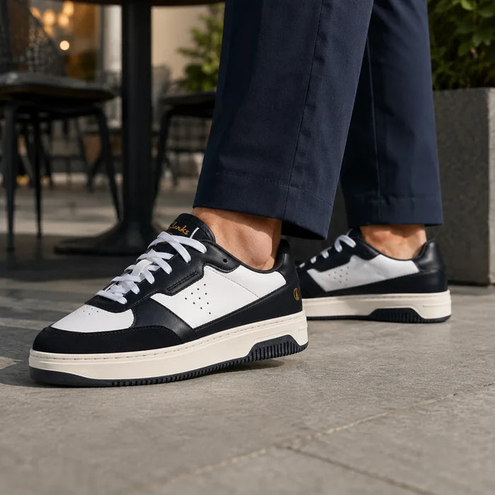 Black and white Clarks Bostock lace-up sneakers with white laces and rubber tread sole