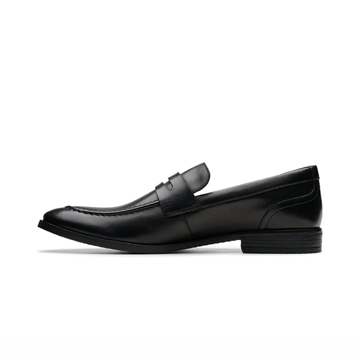 Black leather slip-on loafer with strap detail and low heel, side profile view