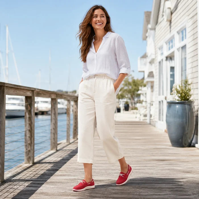 Cherry red canvas loafers on feet with white striped soles