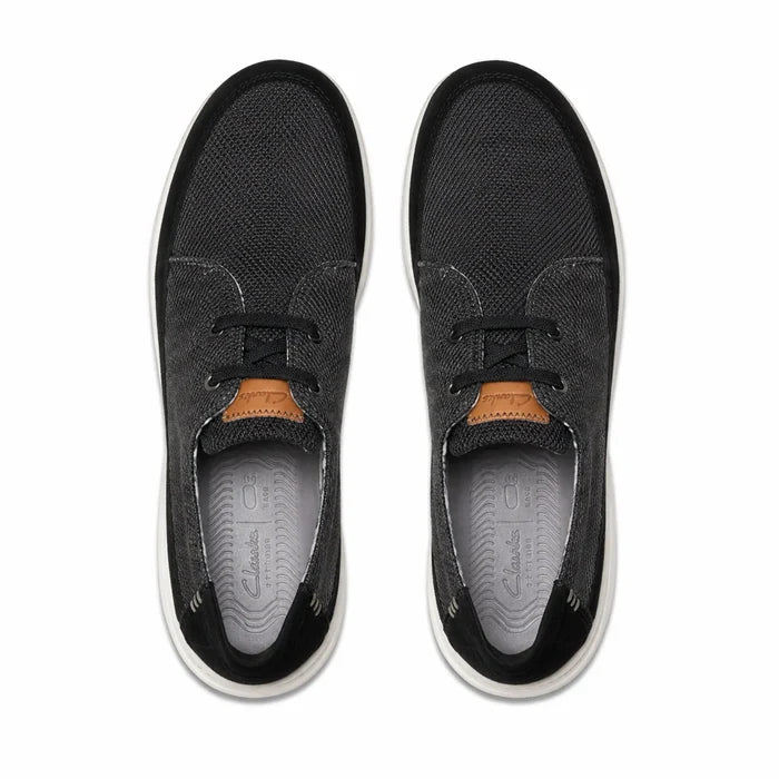 Pair of men's black lace-up sneakers, front view with black laces and textured upper