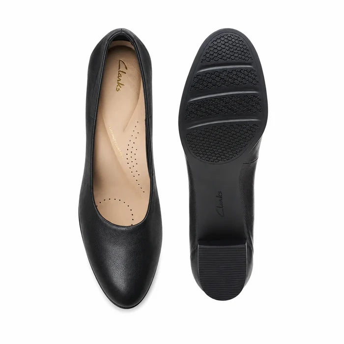 Pair of black leather women's pumps with perforated insole and rubber sole