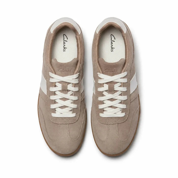 Women's light brown suede sneakers with white lace-up front and rubber sole