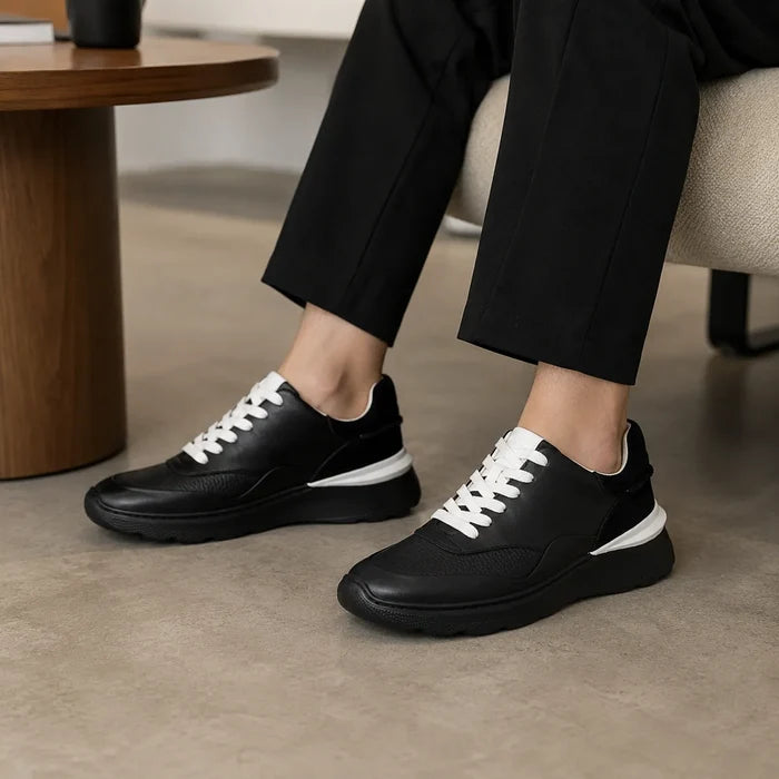Women's black leather lace-up sneakers with white laces and chunky sole