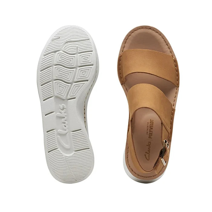 Light tan nubuck sandal with adjustable buckle strap; underside shows treaded sole