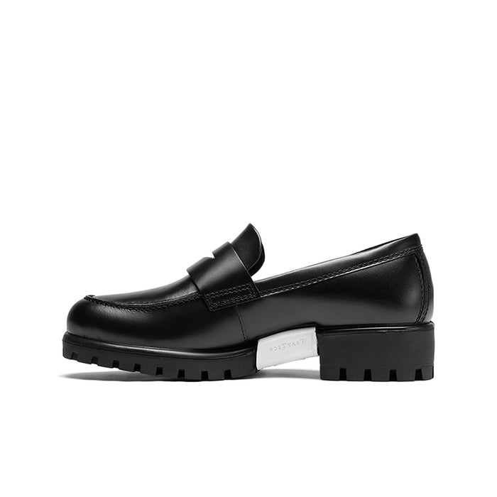 Black leather loafer, side view with strap detail and flat platform sole.
