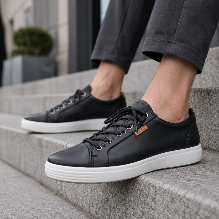 Men's black leather lace-up sneakers with white sole, side view.