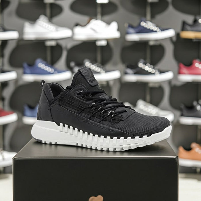 Men's black leather sneakers on box, lace-up design and rugged sole