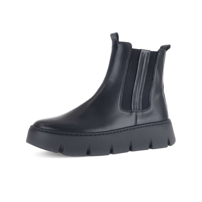 Black leather ankle boots with two side elastic gores and chunky tread sole