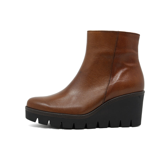 Brown leather mid-calf boot with wedge heel and rugged tread outsole