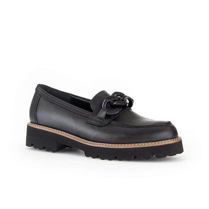 Black leather loafer with tied vamp detail and chunky lug sole, tan welt stitching.