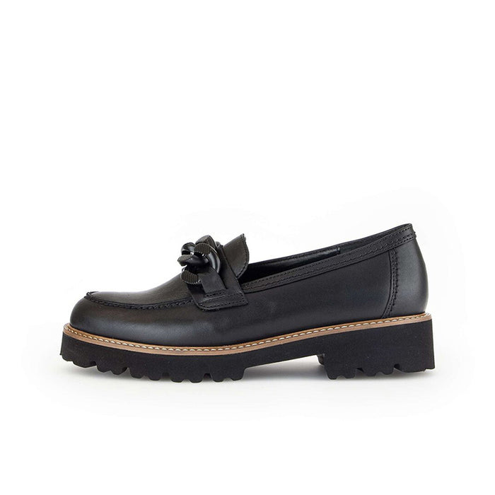 Black leather loafer side view with tied vamp detail and chunky tread sole.
