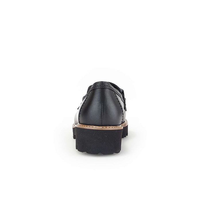 Black leather loafer back view with stacked heel and tan welt trim.