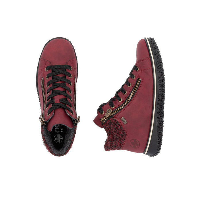 Pair of red lace-up ankle boots with side zipper detail and textured rubber sole