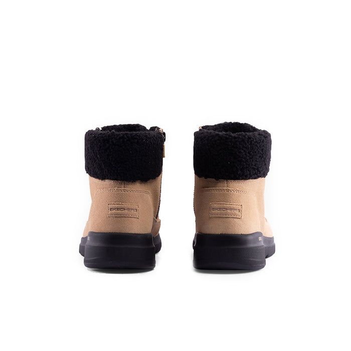Pair of beige boots with black rear collar, lace-up front, and dark rubber heel