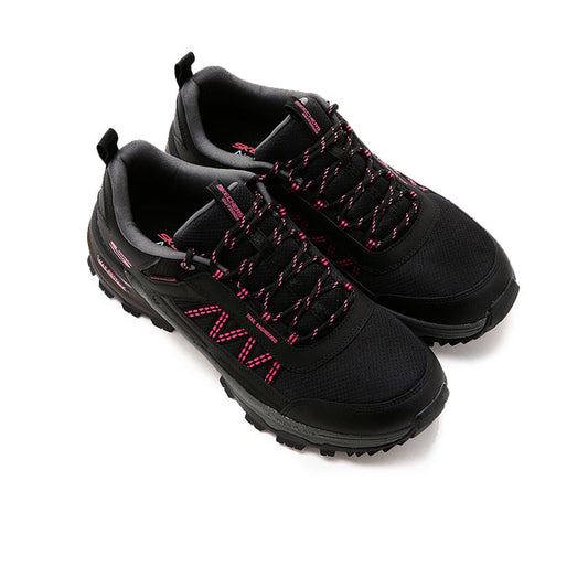 Women's black low-top sneakers with red lace accents and textured knit upper